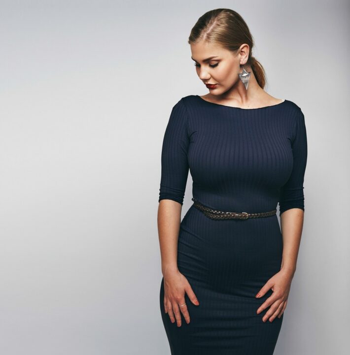 Elegant young lady in black dress 1 - How to Choose the Right Sweater Dress for Your Body Type